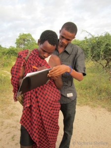 Coordinator George training LG Daudi on how to fill out the Spoor counting data form