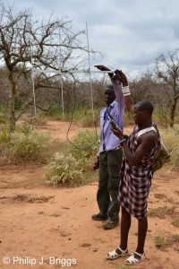 Assistant Program Manager Richard Morinke teaching Darem how to use a telemetry receiver.